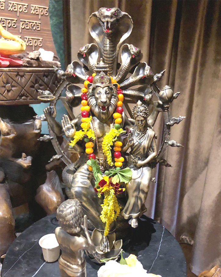 Bronze Narasimha murti garlanded for worship
